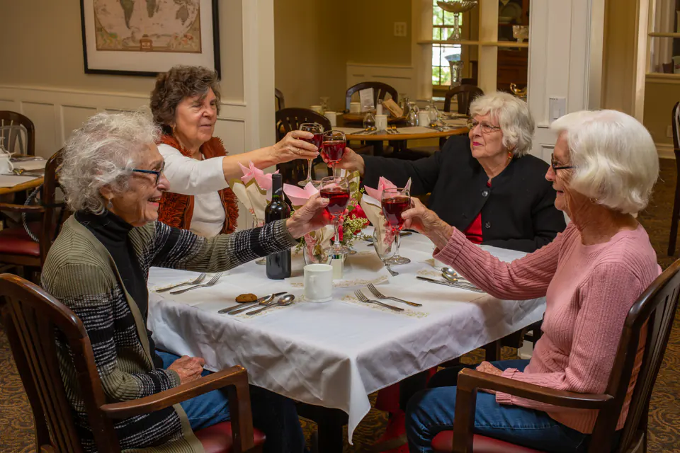 Residents enjoying a celebratory meal together at The Gables of Ojai